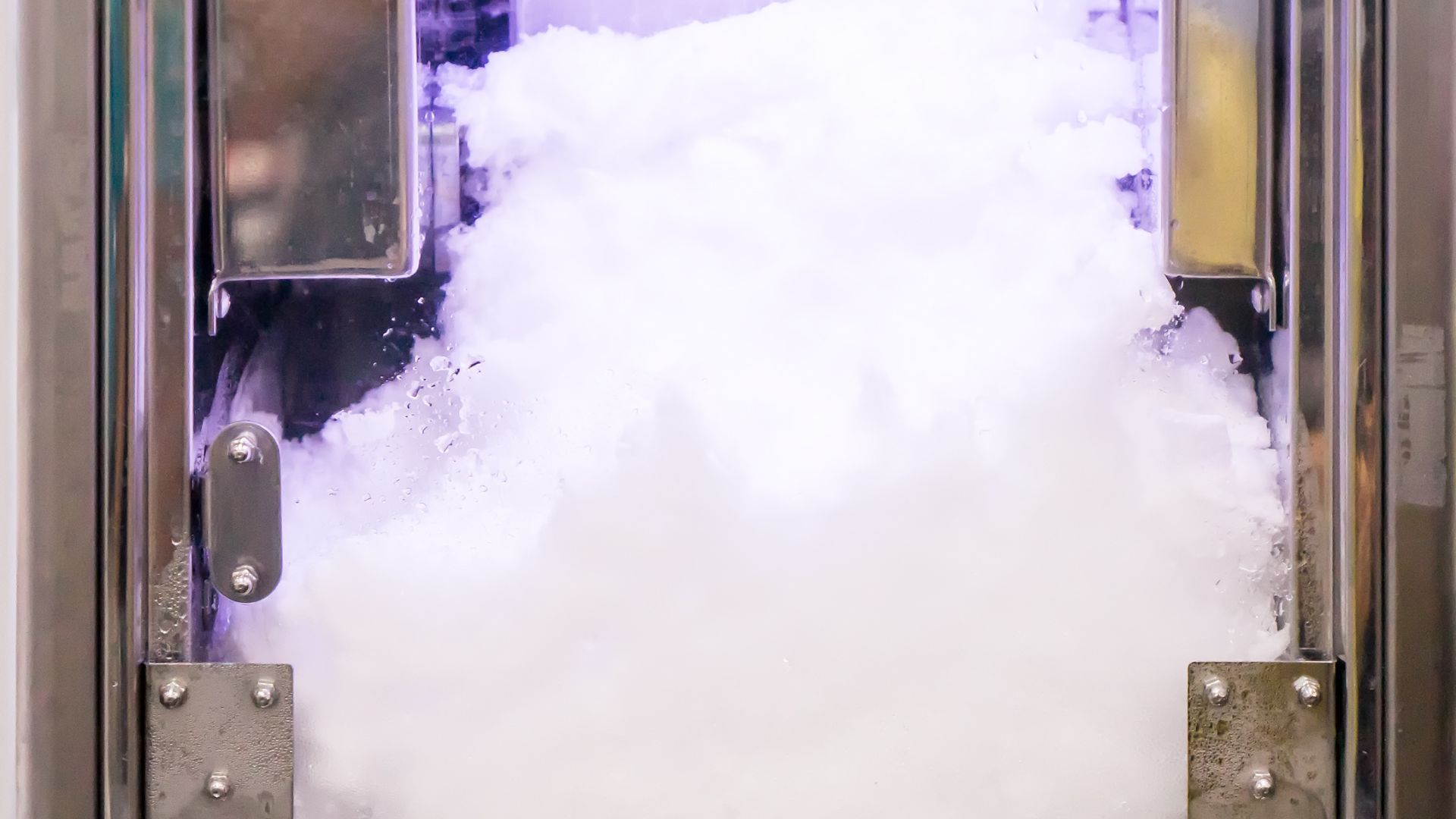 A metal door with a lot of white smoke coming out of it