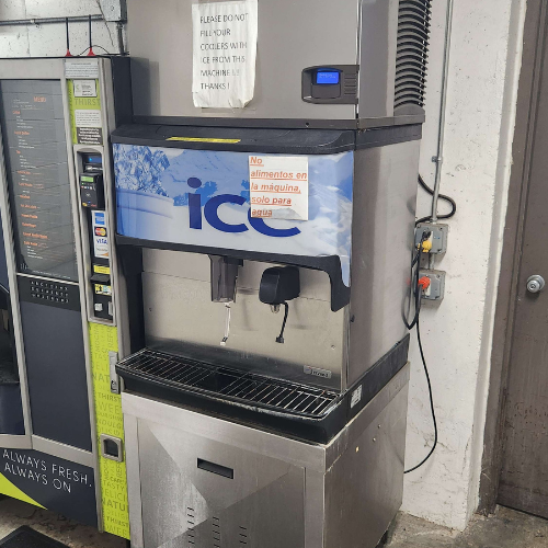 Commercial ice machine with blue logo, dispensing area and control panel